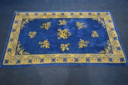 A CHINESE BLUE AND CREAM RUG, 217cm x 120cm