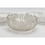 THREE CUT GLASS BOWLS, in matching cut designs, the round bowl being 23cm diameter and 10cm high,