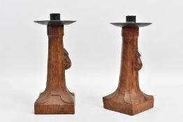 A PAIR OF ROBERT 'MOUSEMAN' THOMPSON OAK CANDLESTICKS WITH CIRCULAR WROUGHT IRON SCONCES, of