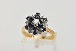 A SAPPHIRE AND DIAMOND CLUSTER RING, a three tier cluster of circular cut sapphires and diamonds,