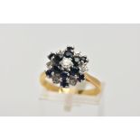 A SAPPHIRE AND DIAMOND CLUSTER RING, a three tier cluster of circular cut sapphires and diamonds,