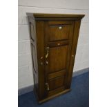 A MODERN OAK AND METAL GUN CABINET, the single door opening to reveal green baize lined interior,