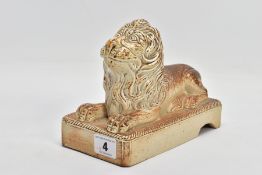 A 19TH CENTURY STONEWARE FIGURE OF A RECUMBANT LION, moulded on a rectangular plinth with rope twist