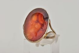 A ROMAN CARNELIAN CAMEO RING, the oval carnelian panel carved with a soldier head, within a collet