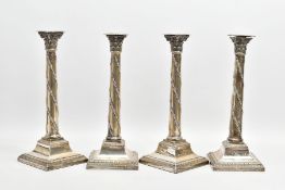 A SET OF FOUR LATE VICTORIAN SILVER CANDLESTICKS, in the Neo-Classical style, each with a