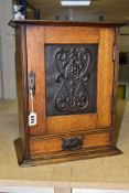 AN EDWARDIAN OAK ARTS AND CRAFTS STYLE RECTANGULAR SMOKERS CABINET, the cabinet is locked and sold