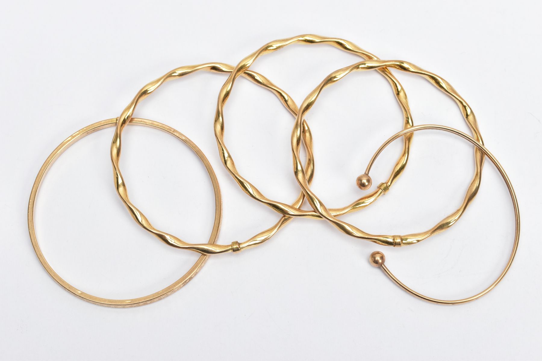 9CT GOLD BANGLES, to include three twisted hollow bangles, hallmarked 9ct gold Sheffield, one