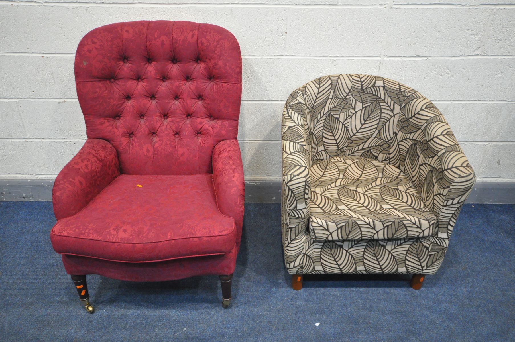 A PARKER KNOLL BUTTONED RED UPHOLSERED ARMCHAIR, on brass caps and casters, along with a floral