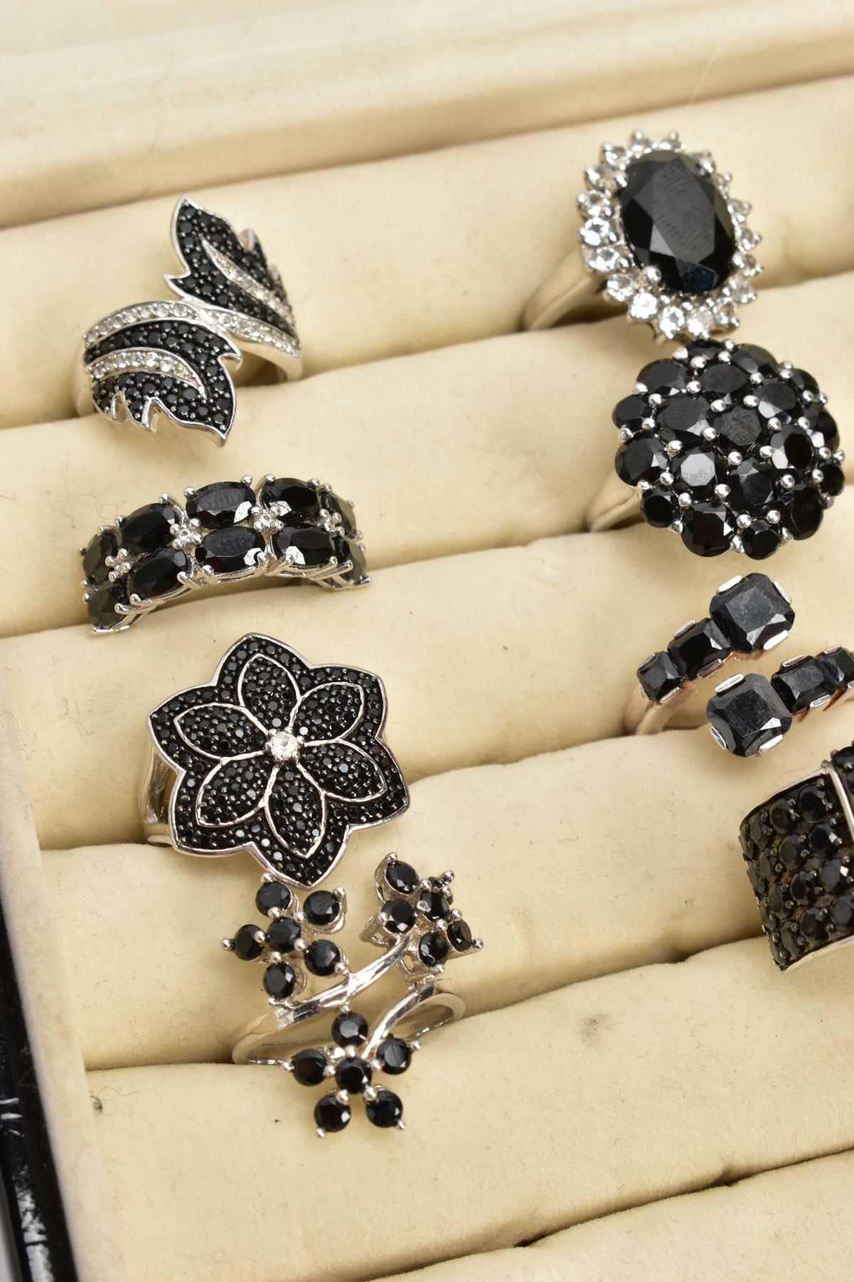 TWELVE BLACK SPINEL RINGS AND A RING BOX, of various designs such as clusters, crossover, half - Image 3 of 4
