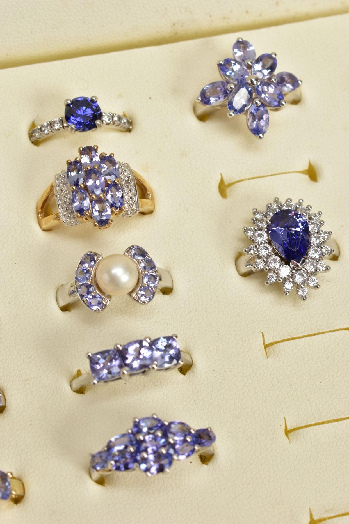 SEVENTEEN GEM SET RINGS AND A RING BOX, most set with vary cut tanzanite's, to include clusters, - Image 2 of 4