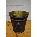 A GEORGIAN MAHOGANY AND EBONISED PEAT BUCKET, circular ribbed form, brass handle and removable