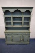 A GREEN PAINTED PINE DRESSER, the top with a fixed cornice, above a shelf with turned supports,