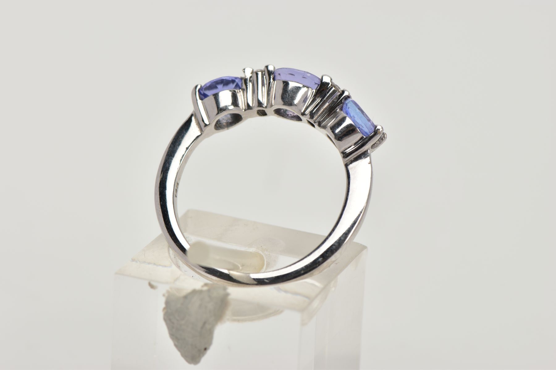 A TANZANITE AND DIAMOND RING, designed as three circular cut tanzanites each interspaced by two - Image 3 of 4