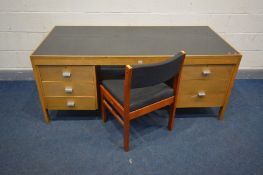 A MID CENTURY TEAK DESK, with a black finish top and five drawers, width 173cm x depth 81cm x height