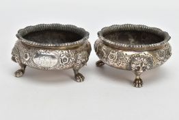 TWO LATE VICTORIAN SILVER SALTS, of circular form, gadrooned rim, embossed floral design with an