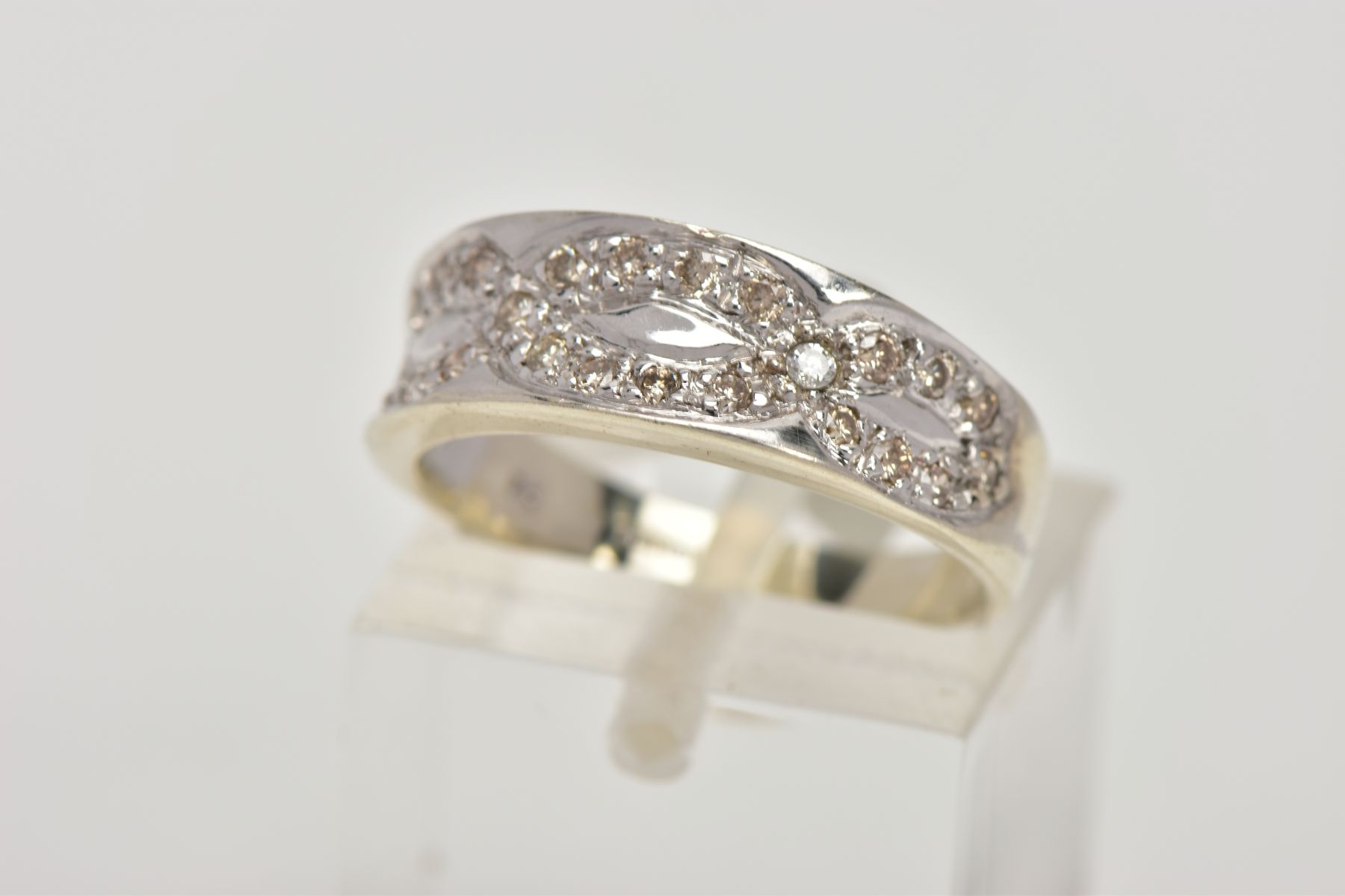 A 9CT WHITE GOLD DIAMOND DRESS RING, the tapered, slightly concave band set to the front half with