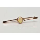 A YELLOW METAL OPAL AND SEED PEARL BAR BROOCH, designed with a central, oval cut opal cabochon