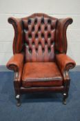 A BURGANDY LEATHER CHESTERFIELD WING BACK ARMCHAIR on mahogany cabriole legs, width 82cm (