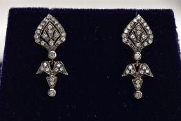 A PAIR OF YELLOW METAL DIAMOND DROP EARRINGS, each of an art deco style set with a small round