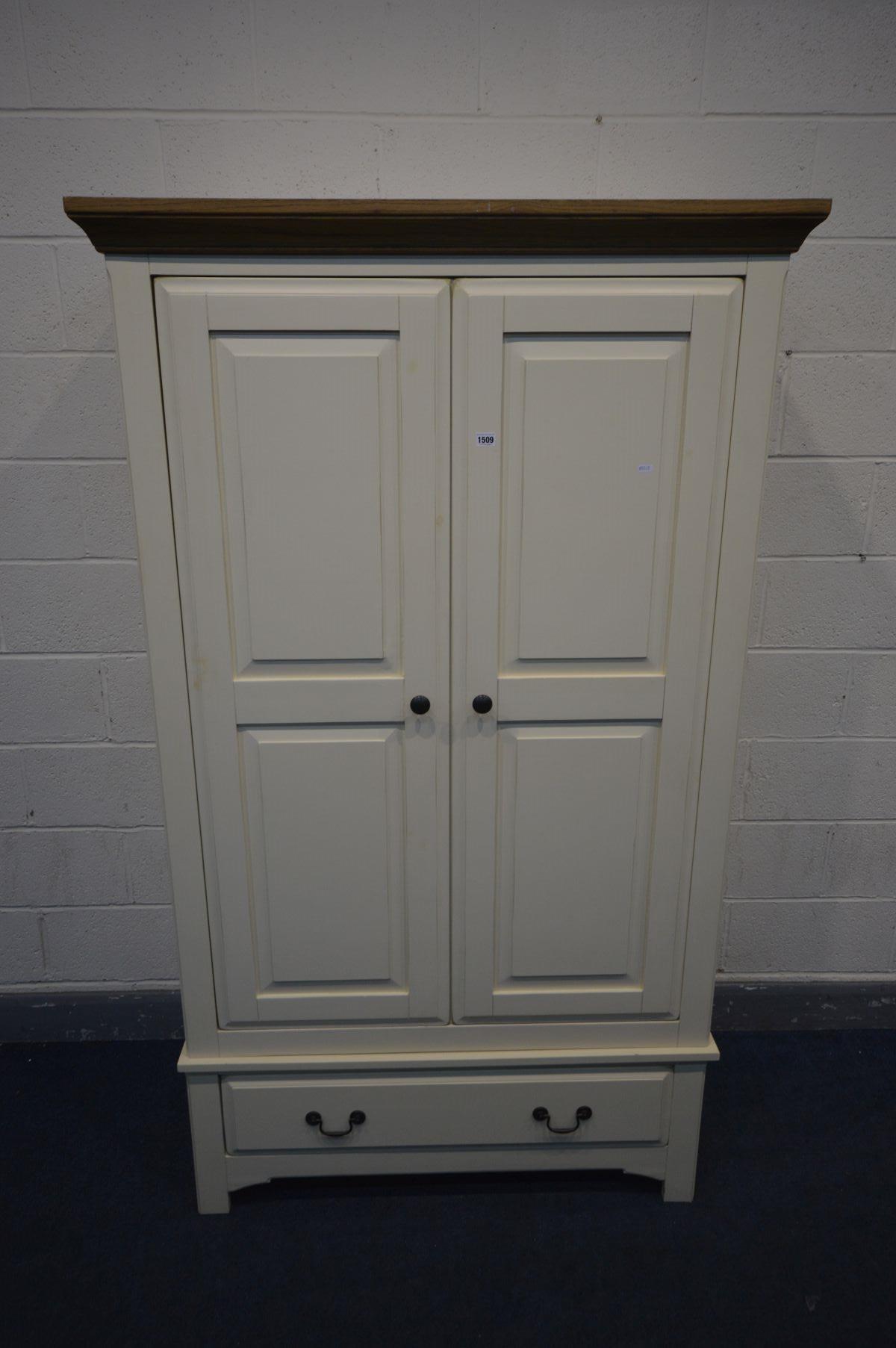 AN OAK AND PARTIALLY PAINTED CREAM DOUBLE DOOR WARDROBE with a single drawer, width 114cm x depth