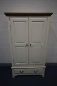 AN OAK AND PARTIALLY PAINTED CREAM DOUBLE DOOR WARDROBE with a single drawer, width 114cm x depth