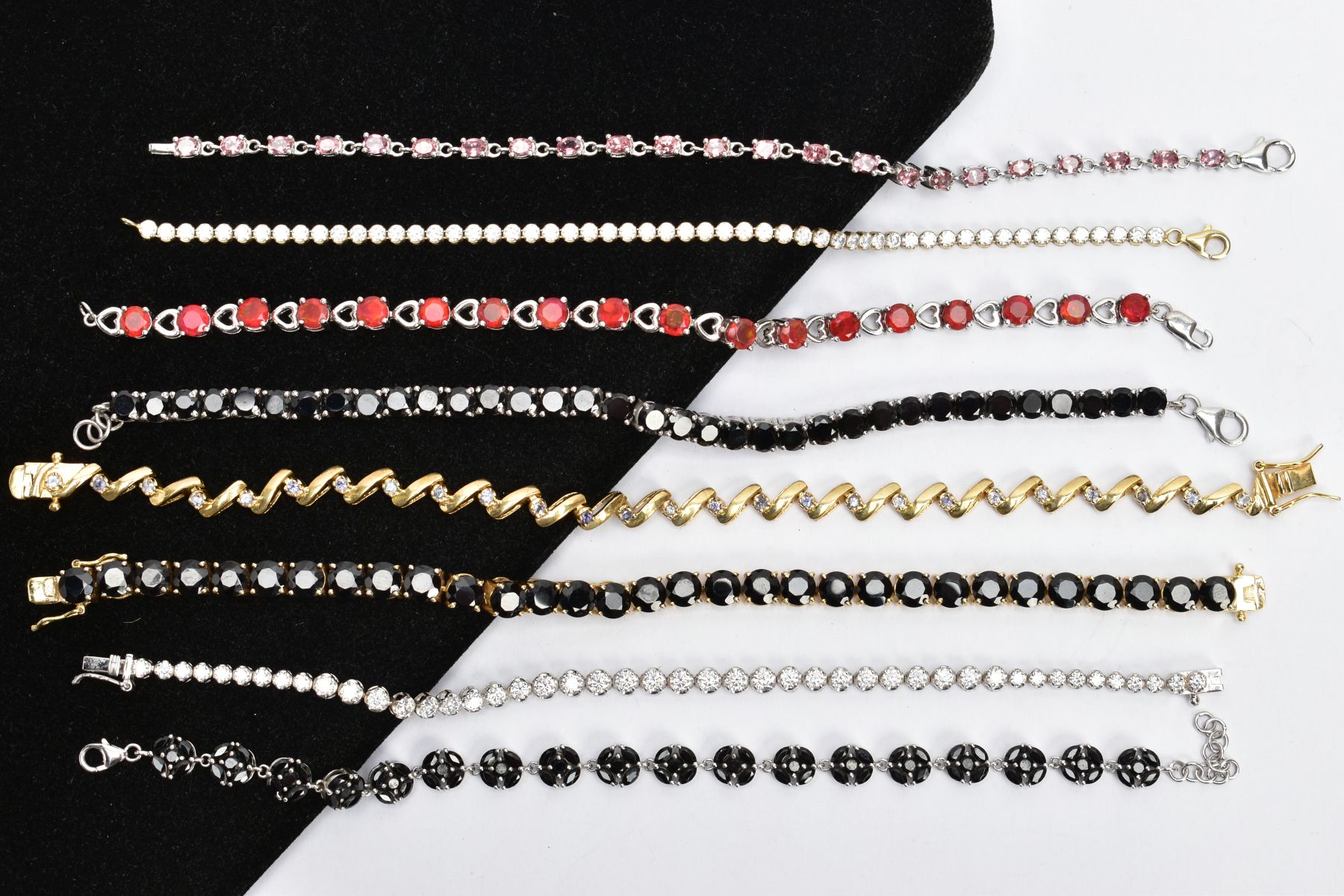 EIGHT GEM SET LINE BRACELETS, to include two circular cut colourless cubic zirconia line