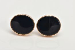 A PAIR OF YELLOW METAL ONYX EARRINGS, each designed with an oval onyx, collet mounted, approximate