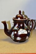 A LATE VICTORIAN BARGEWARE TREACLE GLAZED TEAPOT with applied birds and floral decoration,