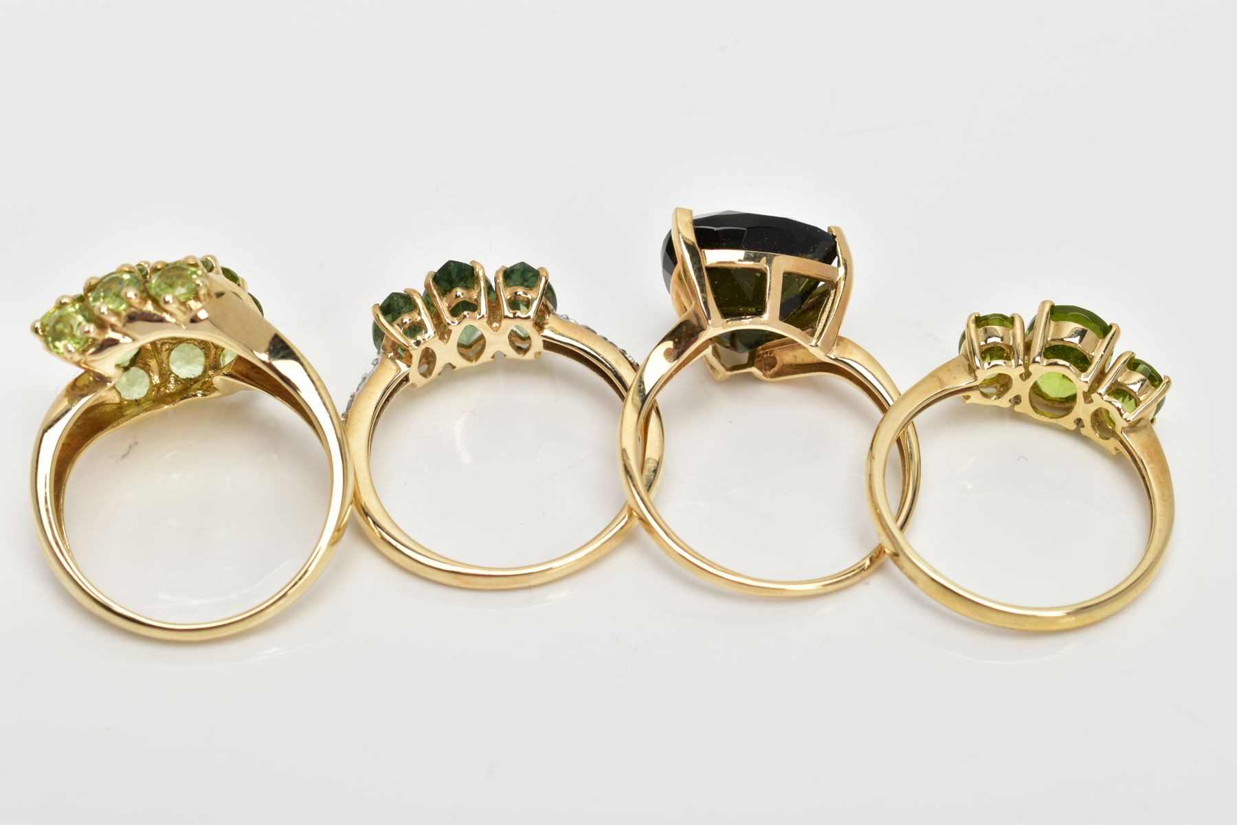 FOUR 9CT GOLD GEMSET RINGS, to include a three stone ring, oval cut peridot, prong set with - Image 3 of 3