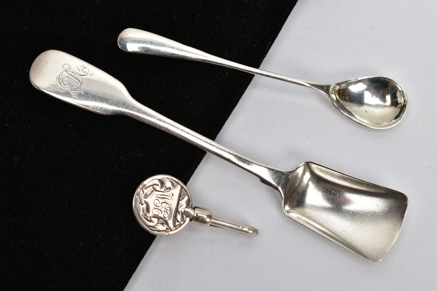 TWO SILVER SALT SPOONS AND A NAPKIN HOLDER, the first a fiddle pattern salt spoon in the form of a