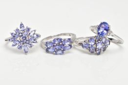 FOUR 9CT GOLD TANZANITE RINGS, oval cut tanzanite, six zircon accent stones, prong set on a slightly