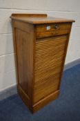 AN OAK TAMBOUR FRONT FILING CABINET, with nine drawers, width 48cm x depth 40cm x height 103cm (