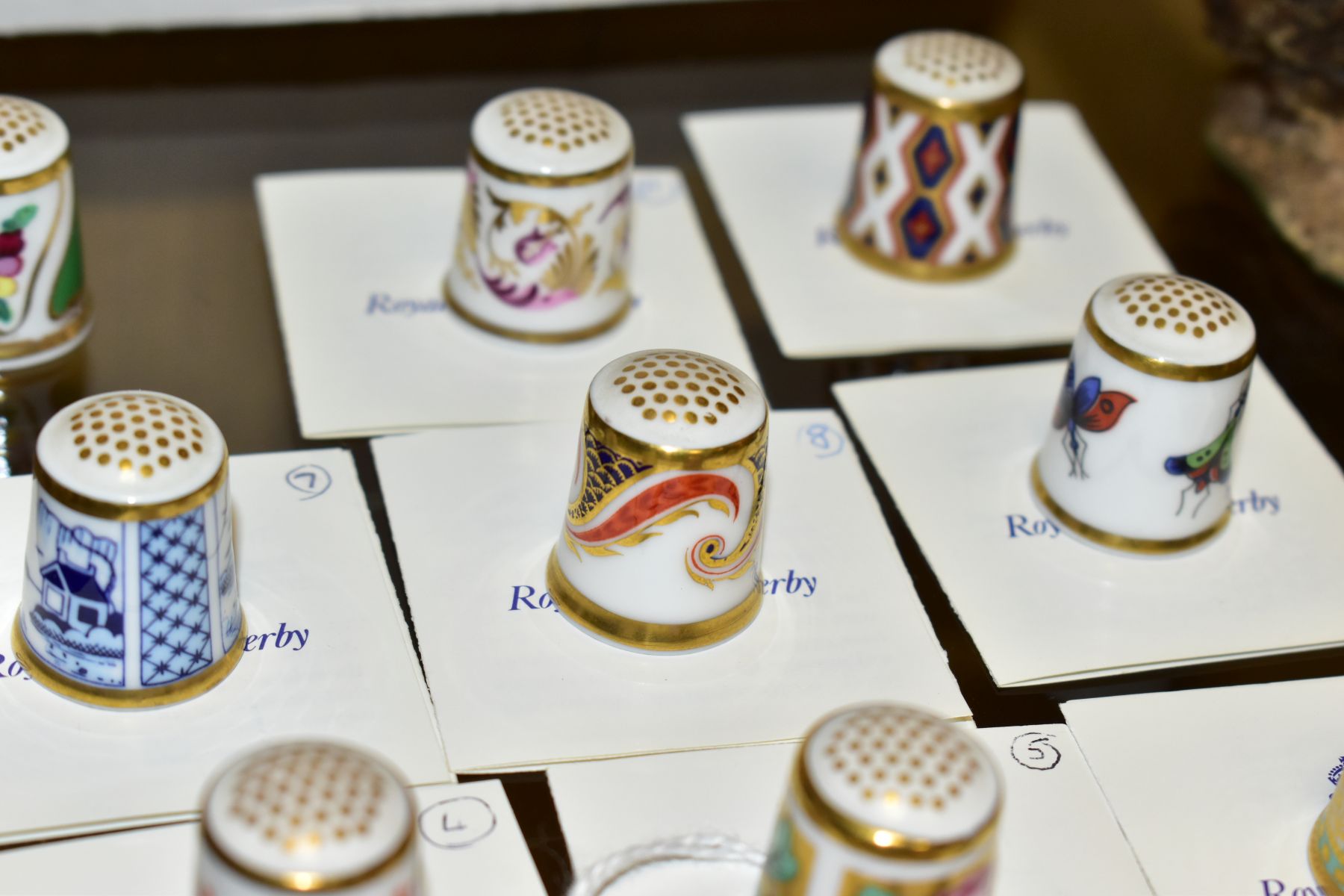 A COLLECTION OF TWENTY ONE ROYAL CROWN CHINA THIMBLES, including a selection from The Historical - Image 4 of 6