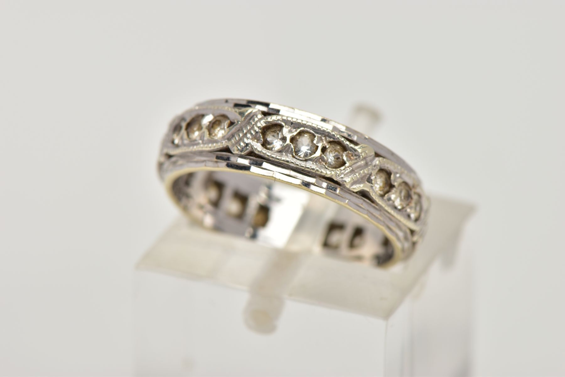 A 9CT WHITE GOLD ETERNITY RING, set with circular colourless gems, assessed as spinel, 9ct hallmark,