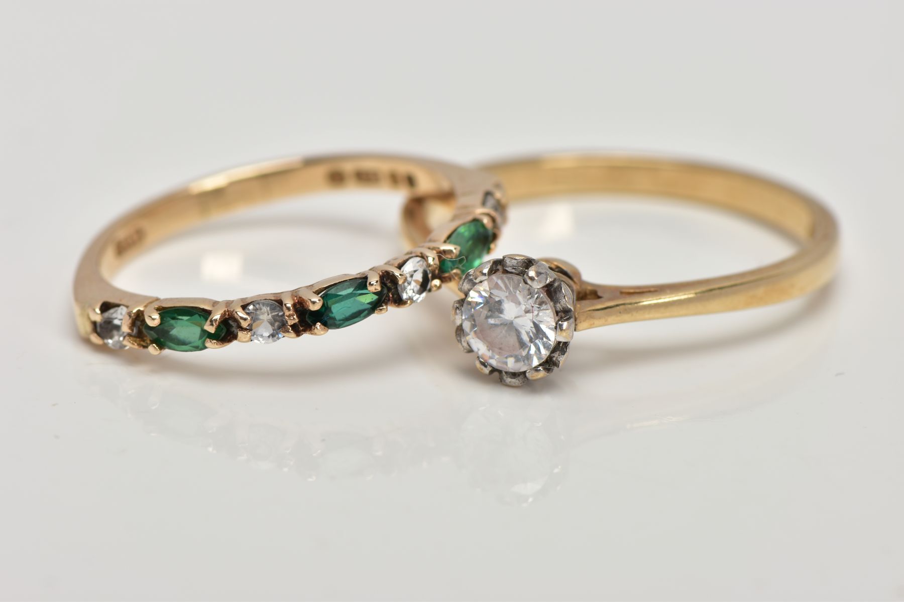 A 9CT GOLD DIAMOND AND EMERALD HALF ETERNITY RING AND A SINGLE STONE RING, the half eternity set