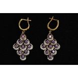 A PAIR OF SILVER GILT DROP EARRINGS, each of a large openwork drop design, set with nine claw set,