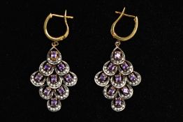 A PAIR OF SILVER GILT DROP EARRINGS, each of a large openwork drop design, set with nine claw set,