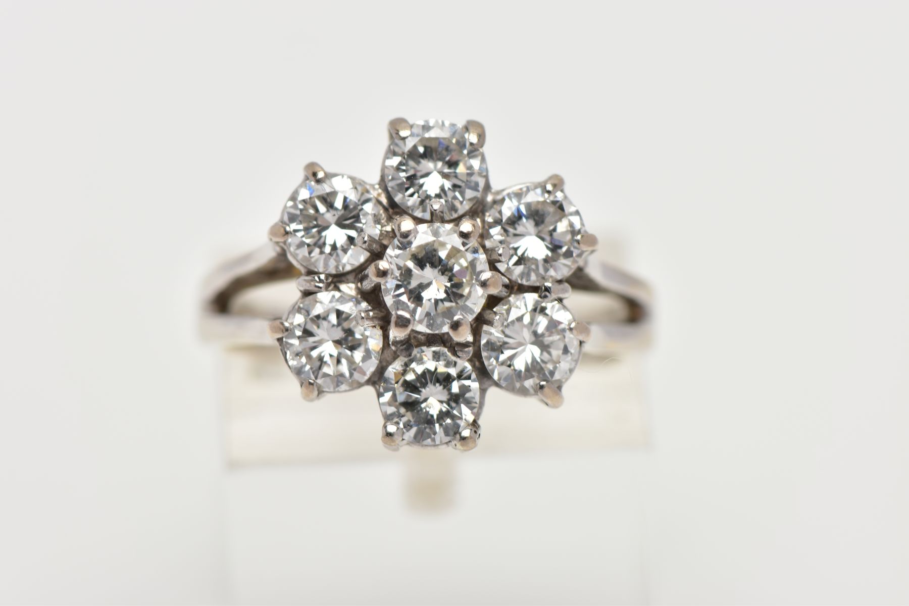 AN 18T WHITE GOLD SEVEN STONE DIAMOND CLUSTER RING, designed as seven claw set brilliant cut - Image 5 of 5