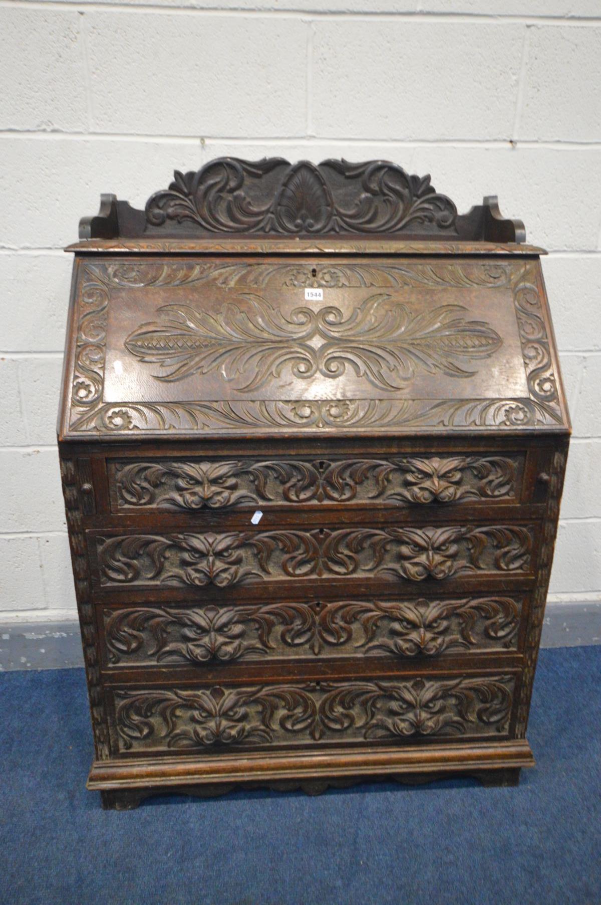 AN EARLY 20TH CENTURY CARVED OAK BUREAU, gallery top, the fall front with a fitted interior, above - Image 2 of 4