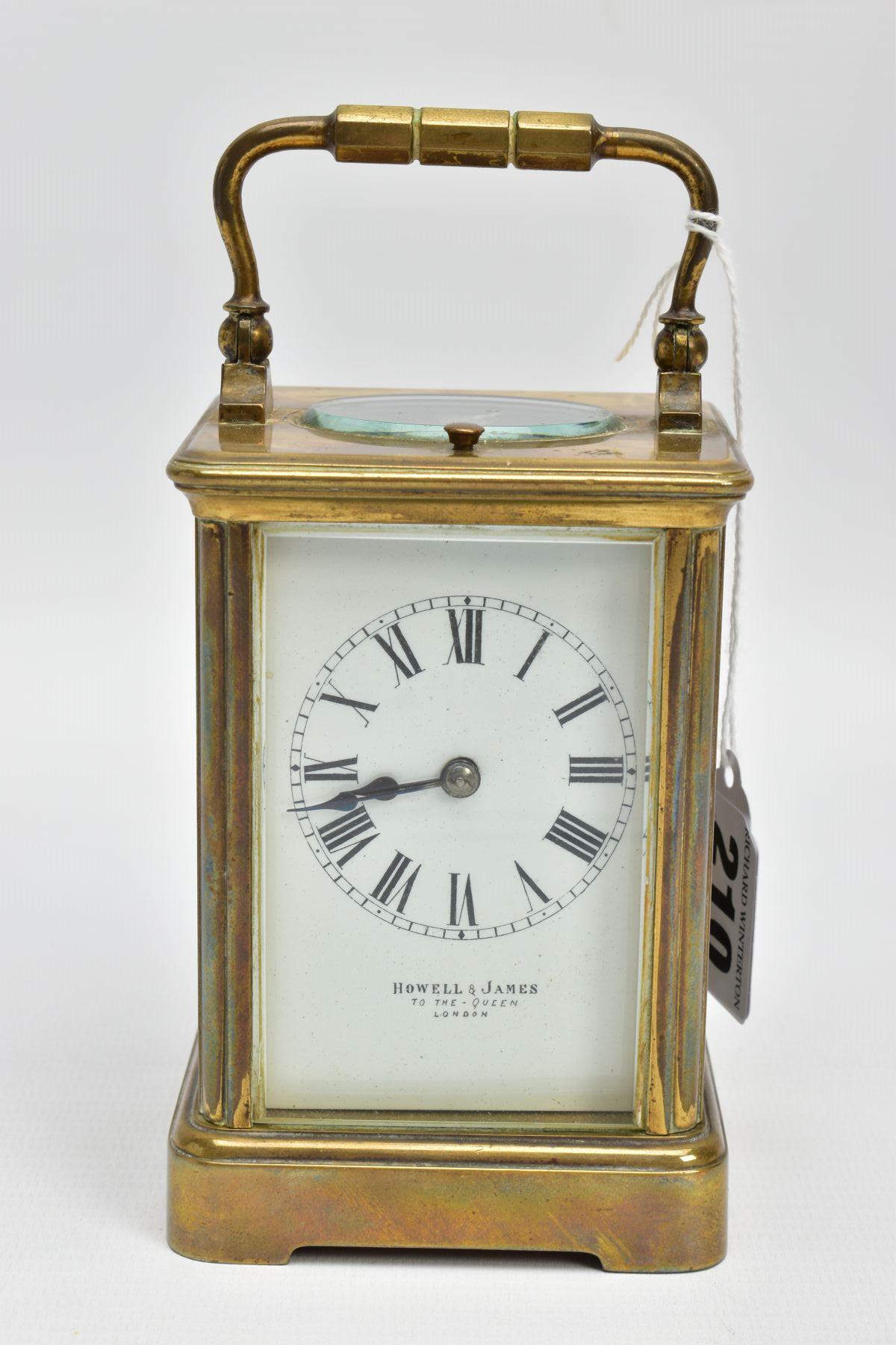 A 'HOWELL & JAMES' BRASS CARRIAGE CLOCK, white dial signed 'Howell & James' to the-Queen London,