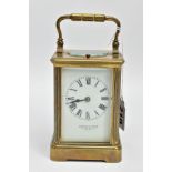 A 'HOWELL & JAMES' BRASS CARRIAGE CLOCK, white dial signed 'Howell & James' to the-Queen London,