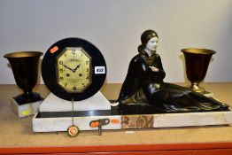 AN ART DECO ONYX, MARBLE, BRONZED SPELTER AND IVORY CLOCK GARNITURE, the clock with reclining female