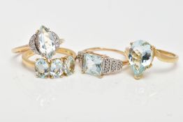 FOUR 9CT GOLD AQUAMARINE RINGS, to include a three stone oval aquamarine ring, a pear shape