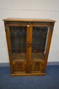 AN WEBBER FURNITURE OAK LEAD GLAZED TWO DOOR BOOKCASE, with two glass shelves, width 92cm x depth