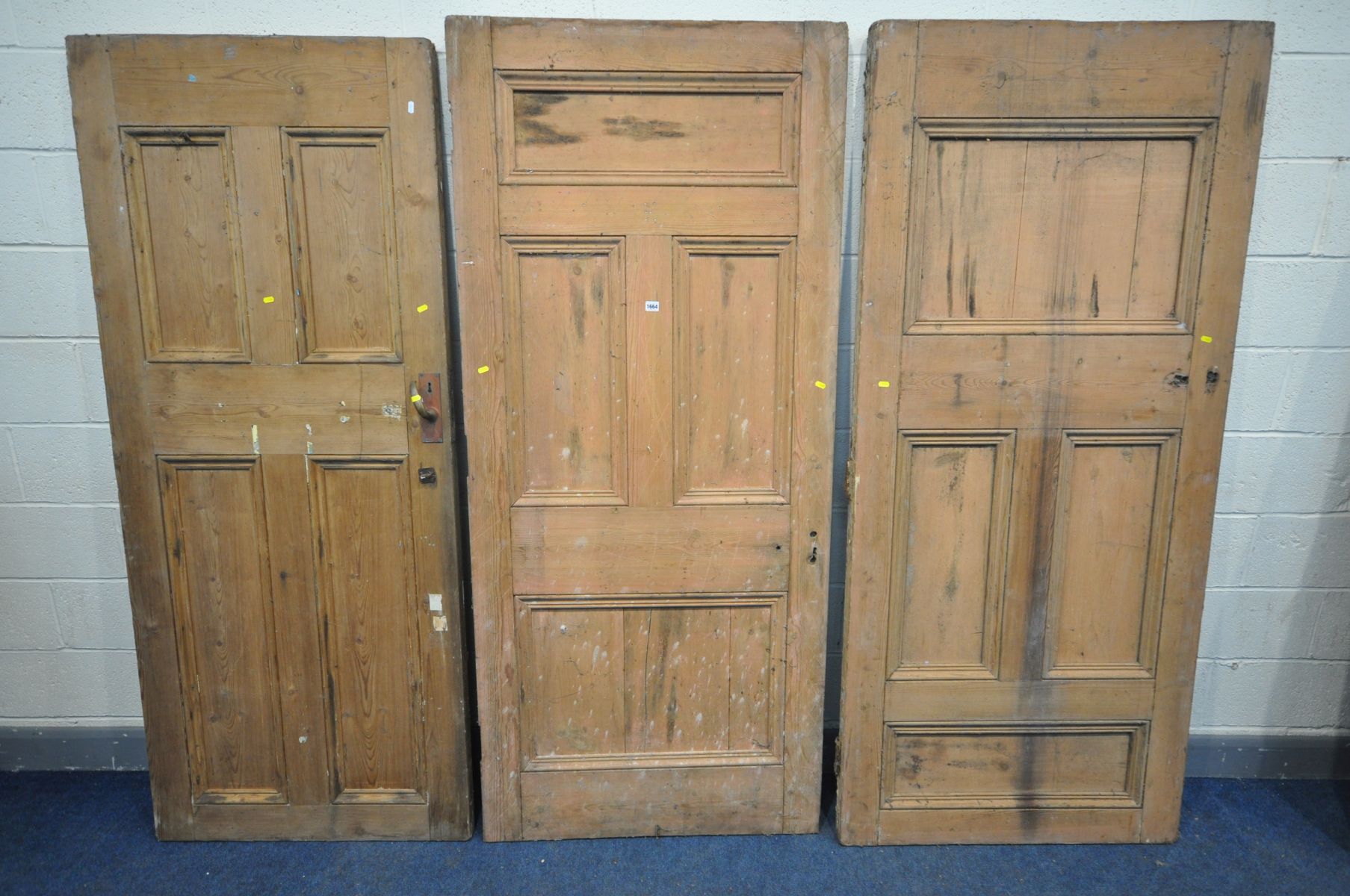 THREE VARIOUS VICTORIAN PINE PANELLED SCHOOLHOUSE DOORS, one with handle, two doors approximately,