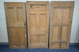 THREE VARIOUS VICTORIAN PINE PANELLED SCHOOLHOUSE DOORS, one with handle, two doors approximately,