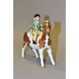 A BESWICK SKEWBALD GIRL ON PONY, No 1499, height 14cm (Condition:- chip to horses's ear)