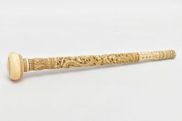 A CARVED IVORY PARASOL HANDLE, carved with a wraparound dragon, butterflies, foliage etc, tapered