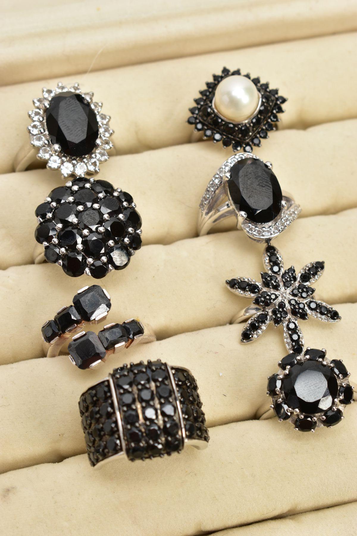 TWELVE BLACK SPINEL RINGS AND A RING BOX, of various designs such as clusters, crossover, half - Image 2 of 4