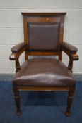 AN EARLY 20TH CENTURY OAK ARMCHAIR, with burgundy leather seat back and arms rests